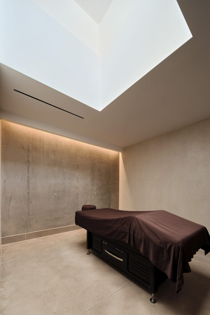 massage table in brutalist spa setting