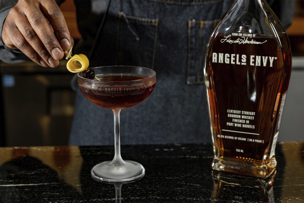 A bottle of Angel's Envy is poured into a glass 