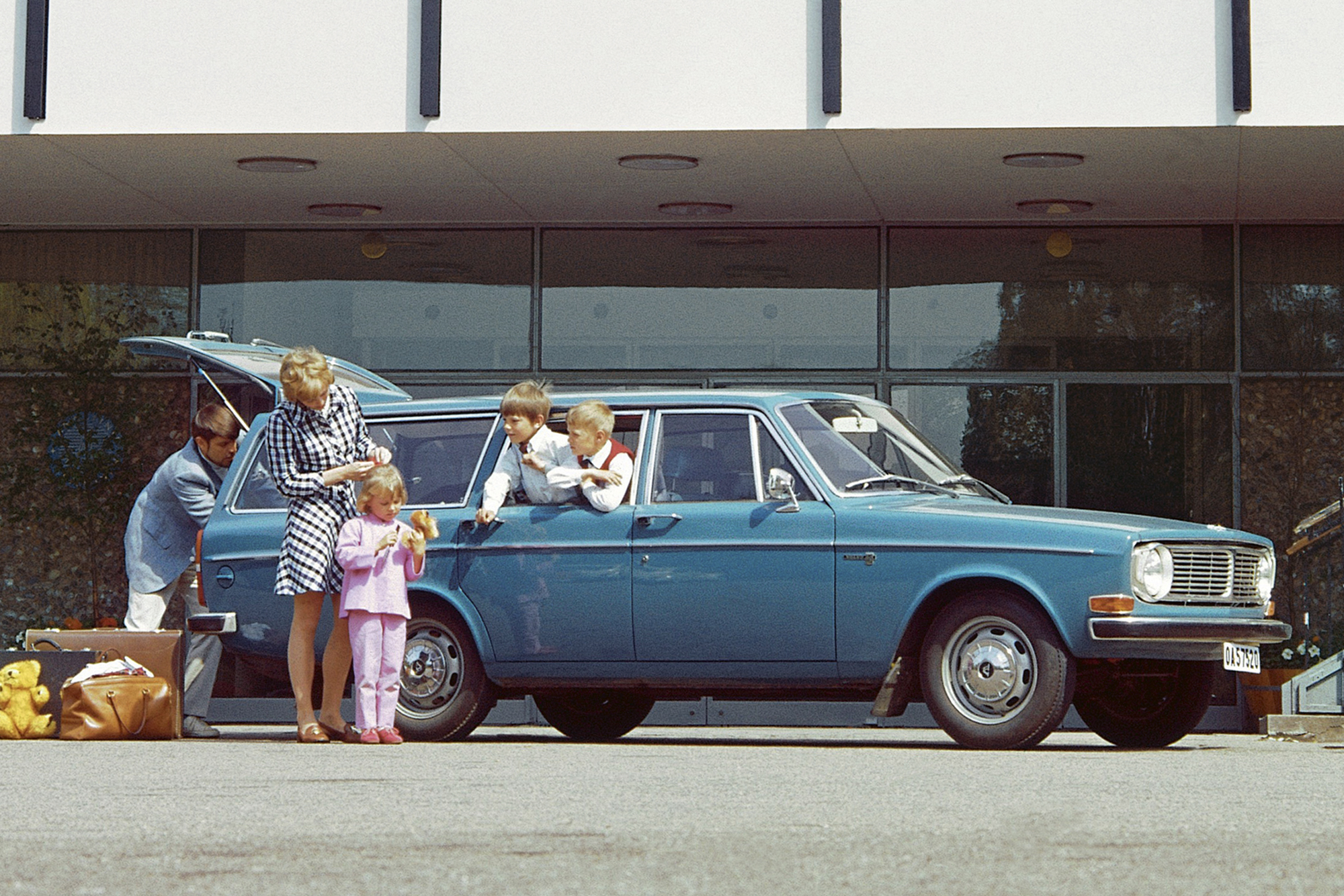 family packs up blue station wagon photo from the atlas of car design