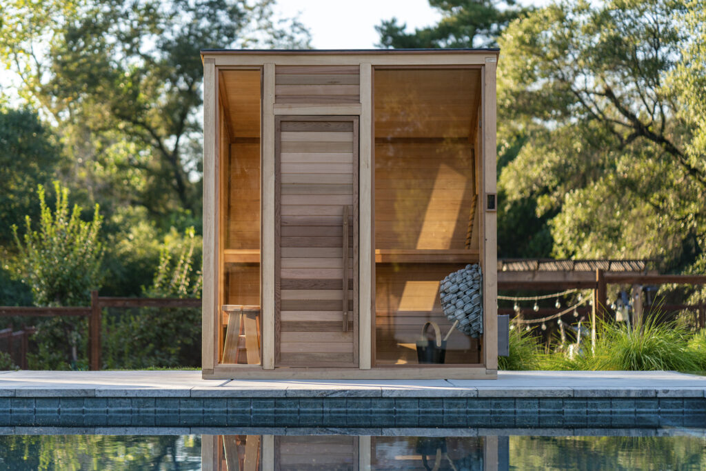 Plunge sauna installed by an outdoor pool
