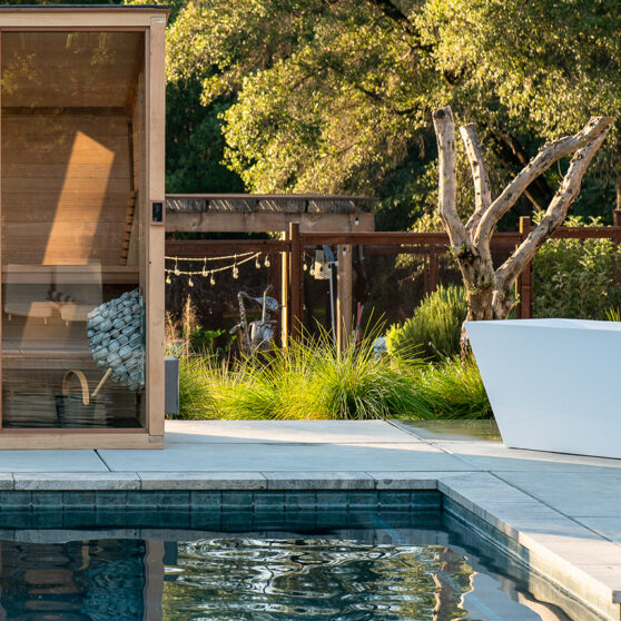 Plunge sauna installed by an outdoor pool
