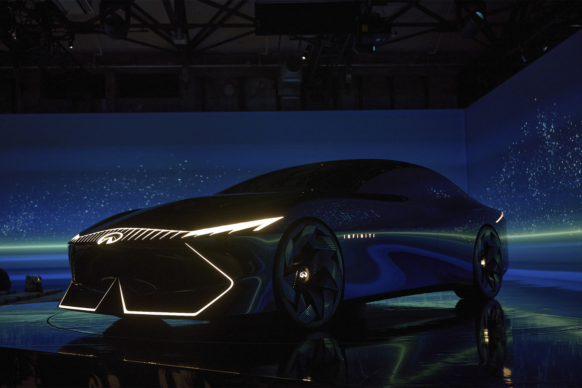 Infiniti Vision Qe on stage with blue and green lighting