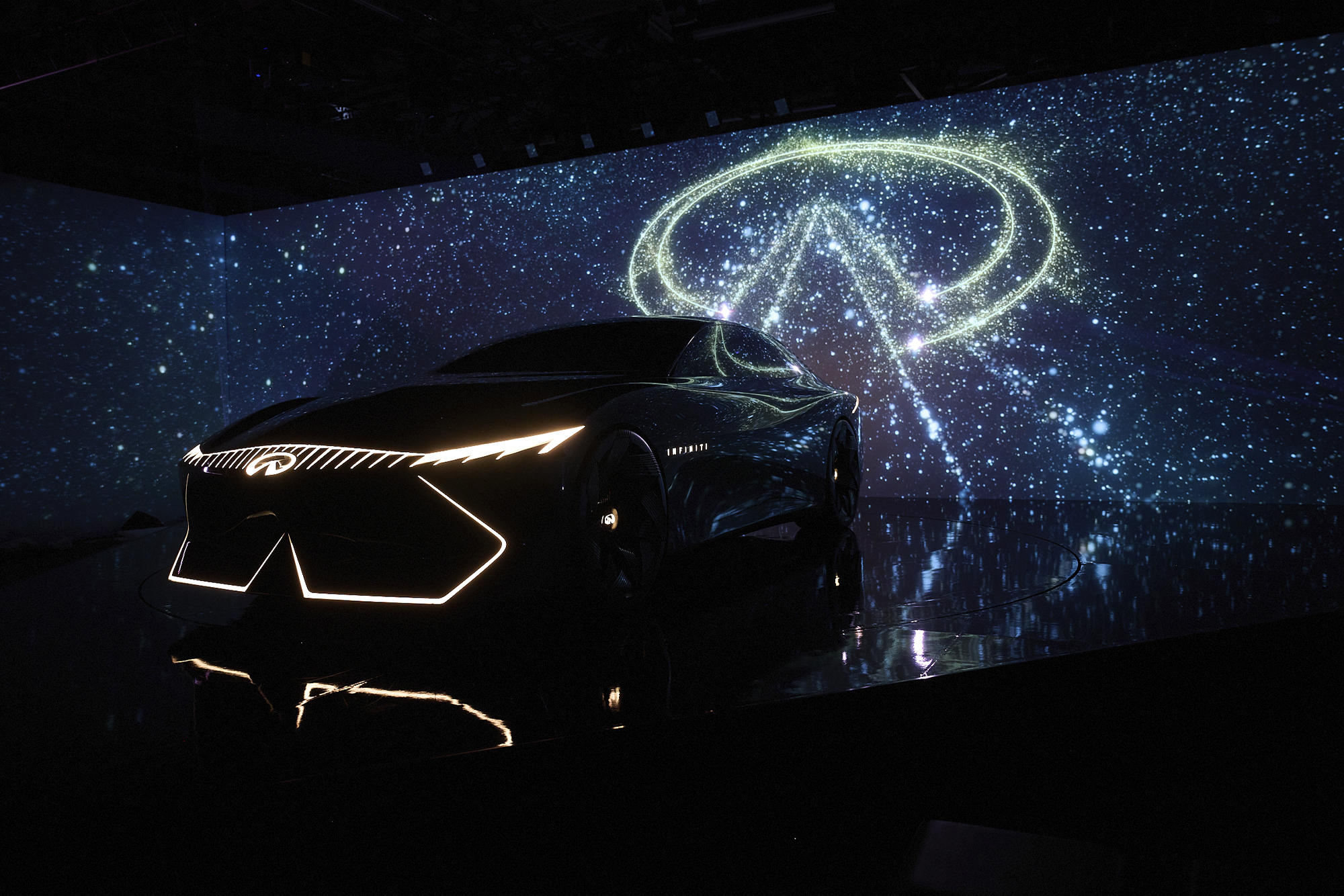 Infiniti Vision Qe on a stage with infiniti logo in. the back