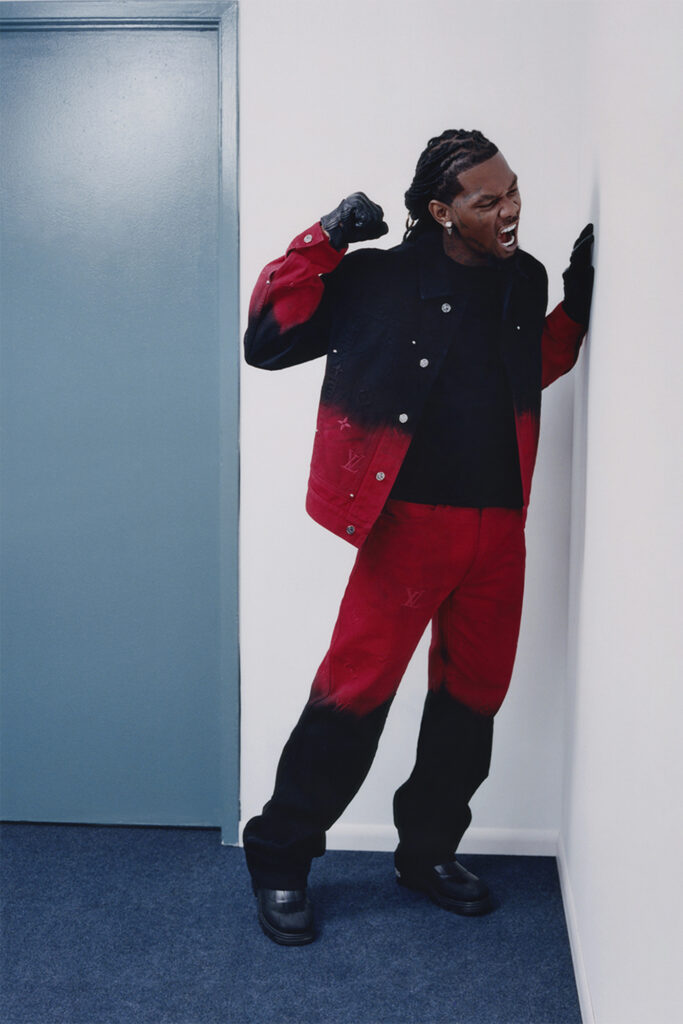 Offset interview on off the wall for Sharp November, rapper in red and black outfit, punching white wall