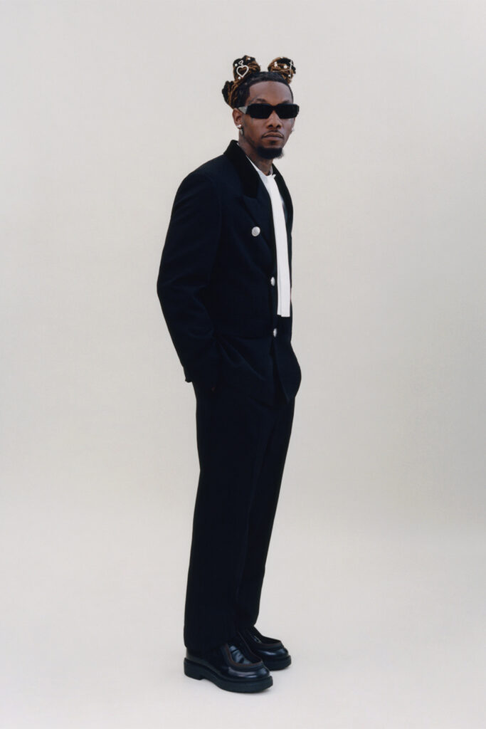 Offset interview on off the wall for Sharp November; rapper in a suit with glasses on white background