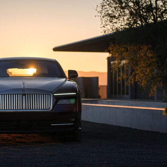 Rolls-Royce Spectre parked outside a house during sunset