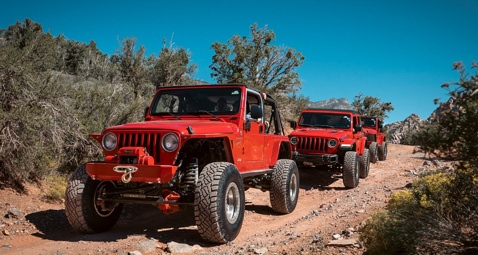 Red Jeep Wranglers driving with Sailun tires off-road in the desert