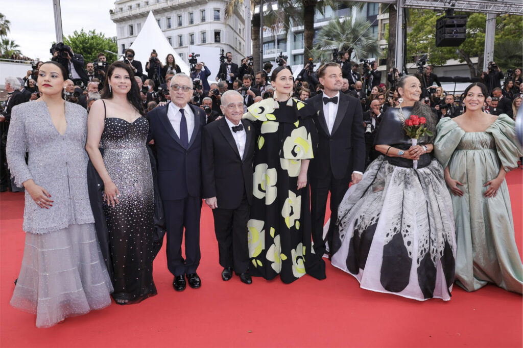 the cast of the killers of the flower moon posing on a red carpet at Cannes Film Festival