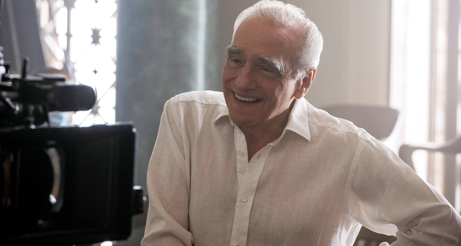 Martin Scorsese laughing in a white button-down shirt