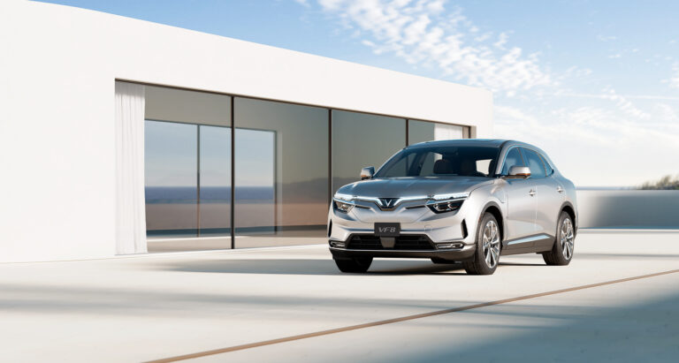 Vinfast silver suv parked outside a modern home