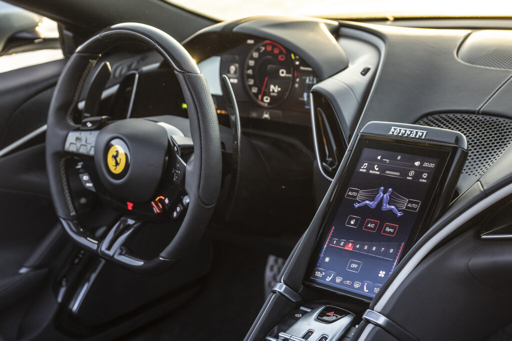 Inside of Ferrari Roma Spider showing dashboard and steering wheel