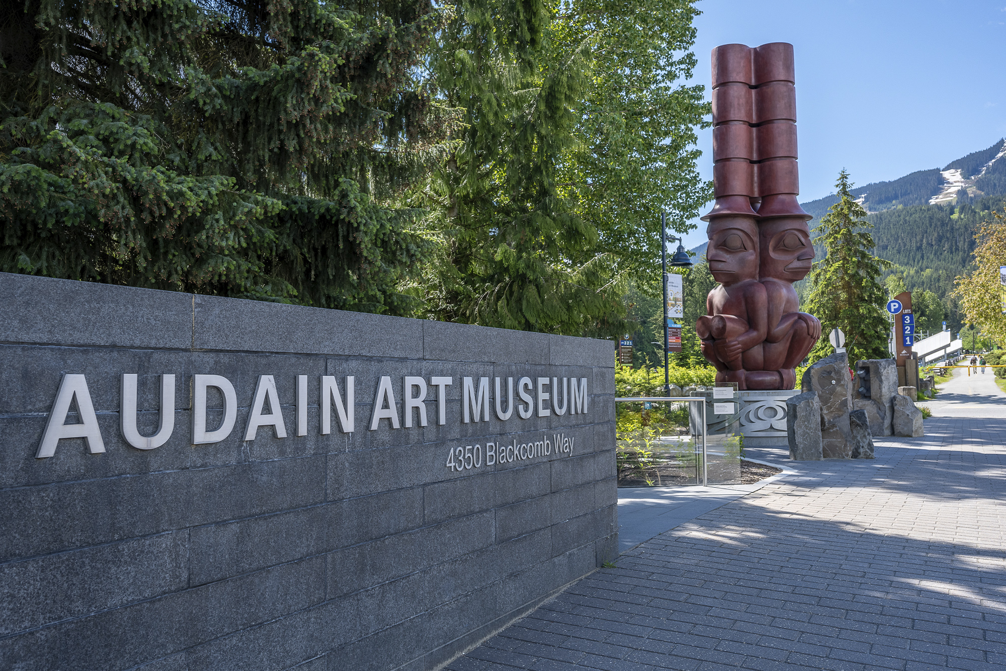 James Hart, The Three Watchmen, c. 2021, bronze with red ocher patina, Audain Art Museum Collection, Funded by the Audain Foundation. Xwalacktun and Levi Nelson, Ti A7xa7 St'ak' (The Great Flood), 2021, waterjet cut aluminum and concrete, Audain Art Museum Collection, Funded by the Audain Foundation. Image by Scott Brammer Photography.