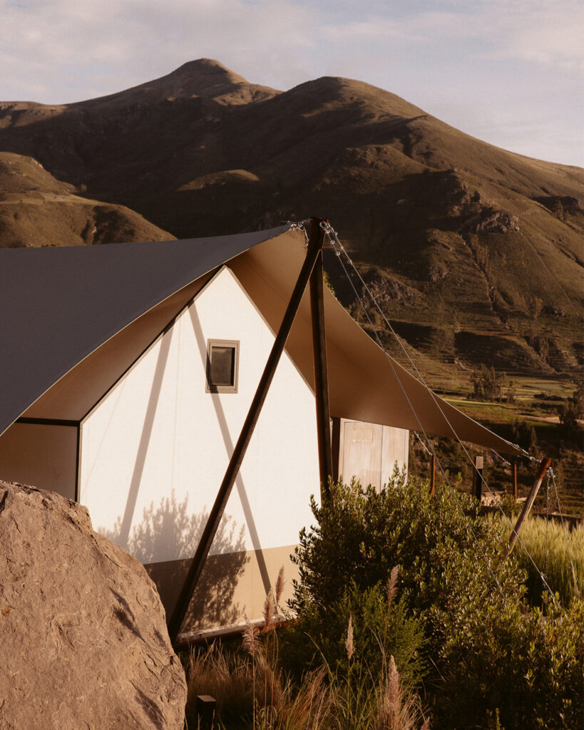 PUQIO Tented Resort in Southern Peru, exterior shot of resort during golden hour with mountains