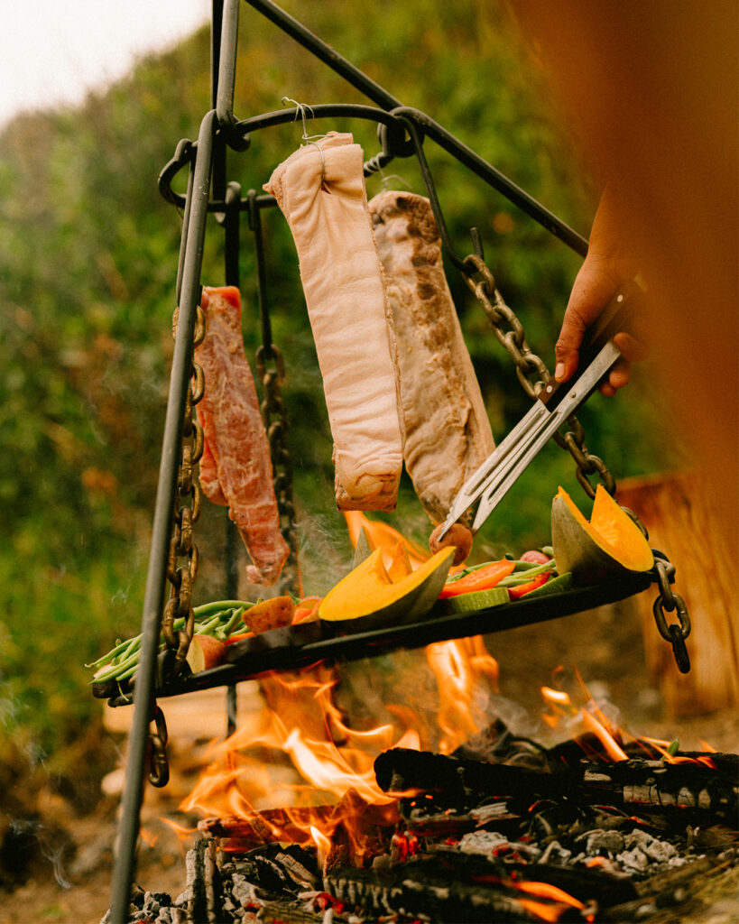 cooking food over an open fire at PUQIO Tented Resort in Southern Peru