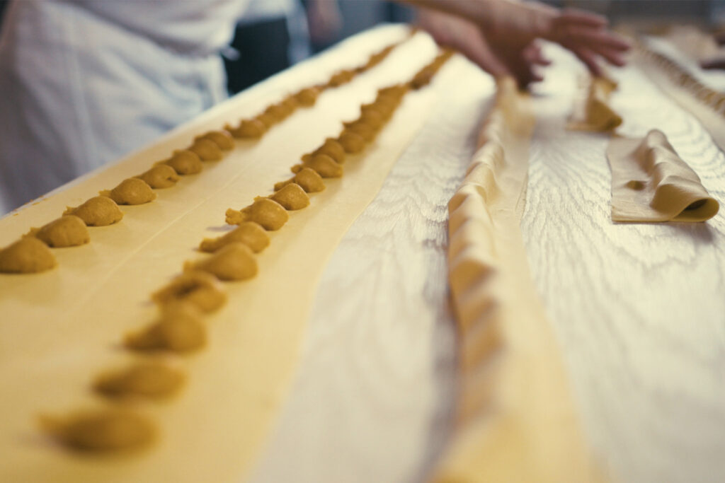 Lines of pasta on a brown table, preparing for the Sagra di Toronto festival