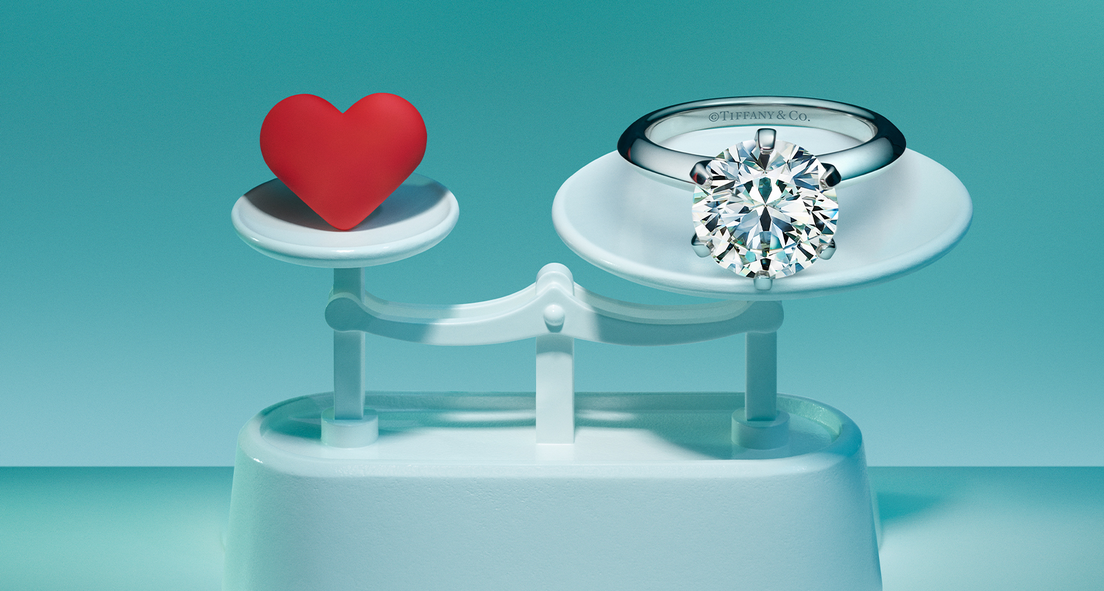 Tiffany jewellery stand with a red heart on the left side and diamond ring on the right