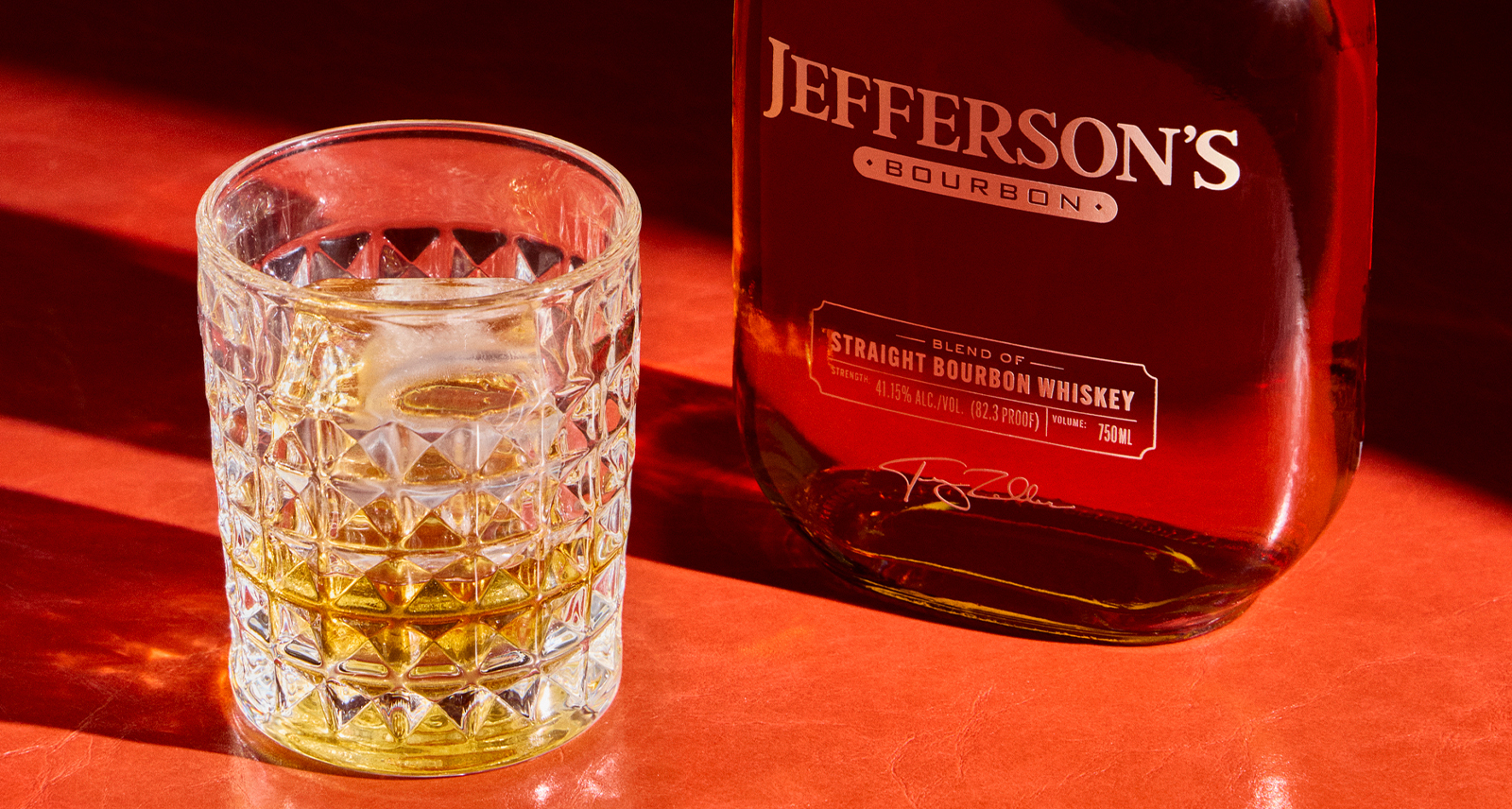 Jefferson's Bourbon on a red table with a glass