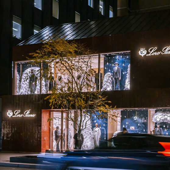 Loro Piana Toronto Opening. Storefront at night, with a car speeding by in front.