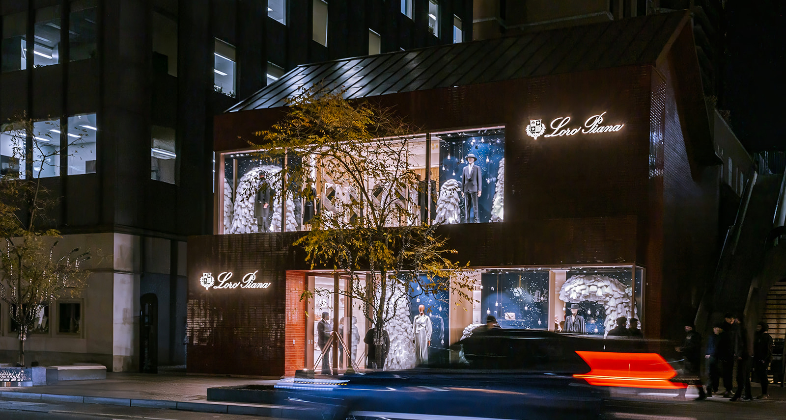 Loro Piana Toronto Opening. Storefront at night, with a car speeding by in front.