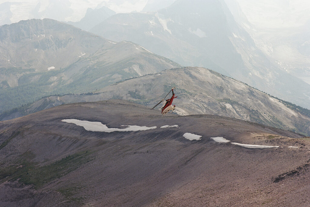 Trip to Alberta to celebrate Citizen Promaster 35-Year Anniversary. helicopter flies over mountain