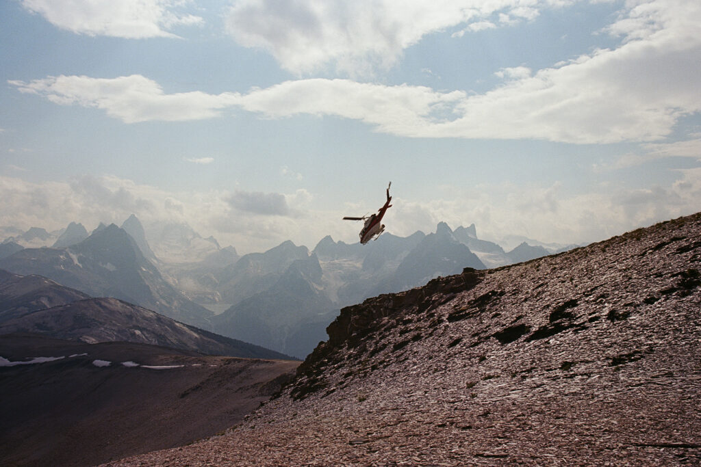 Trip to Alberta to celebrate Citizen Promaster 35-Year Anniversary. helicopter flies over mountain