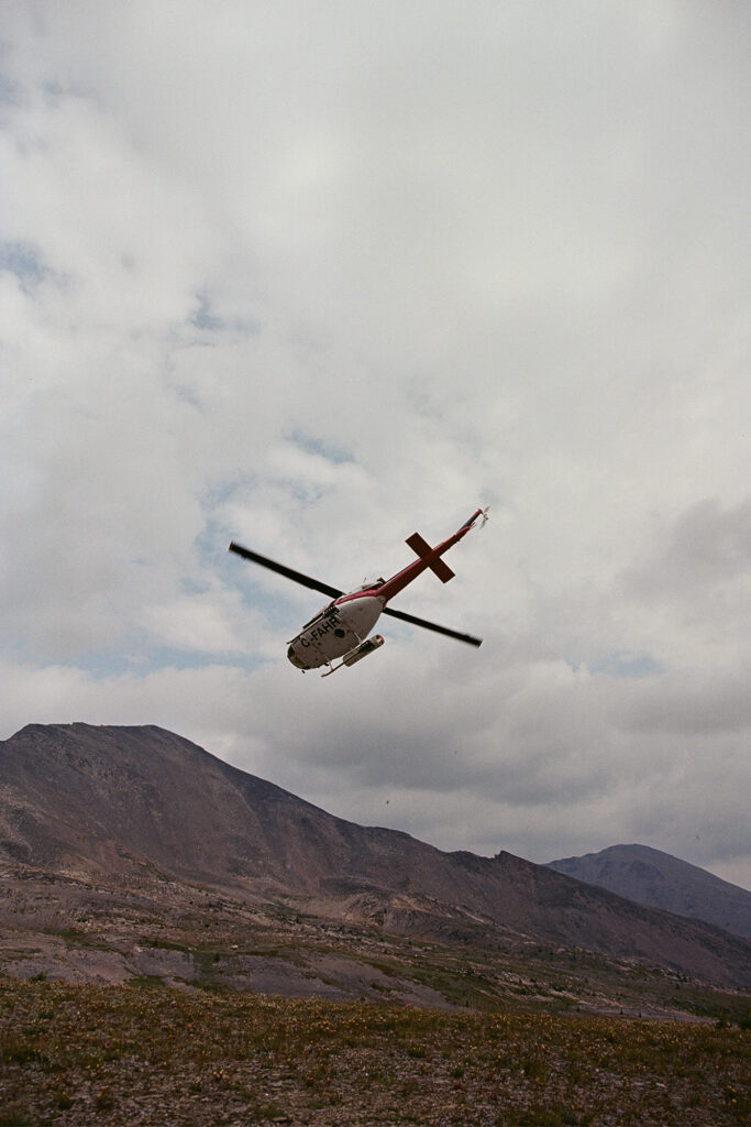 Trip to Alberta to celebrate Citizen Promaster 35-Year Anniversary. helicopter flies over mountain