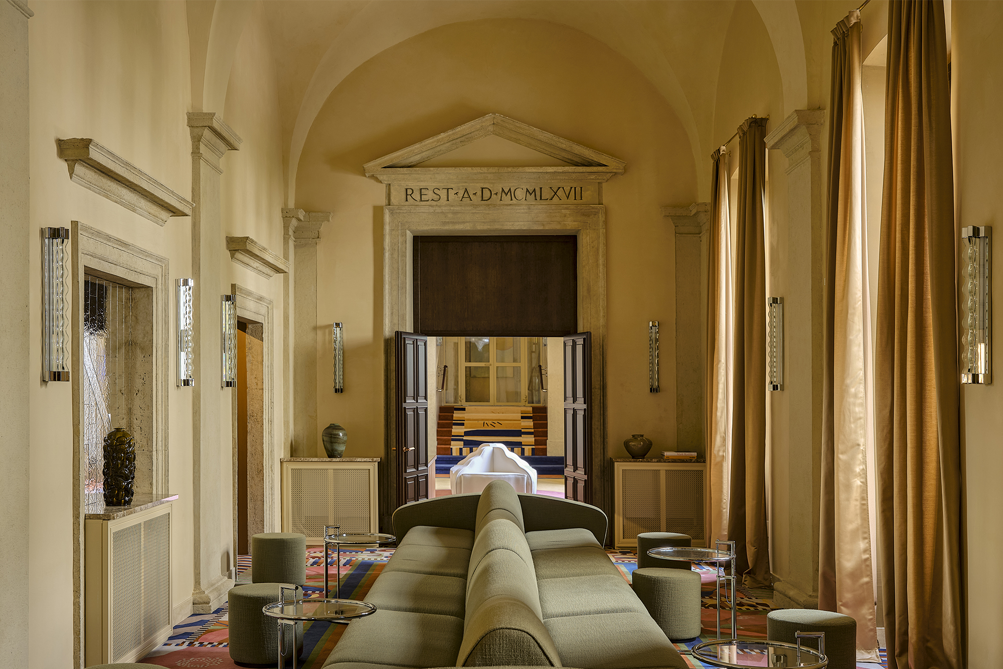 arched yellow walls and ceilings with two green couches