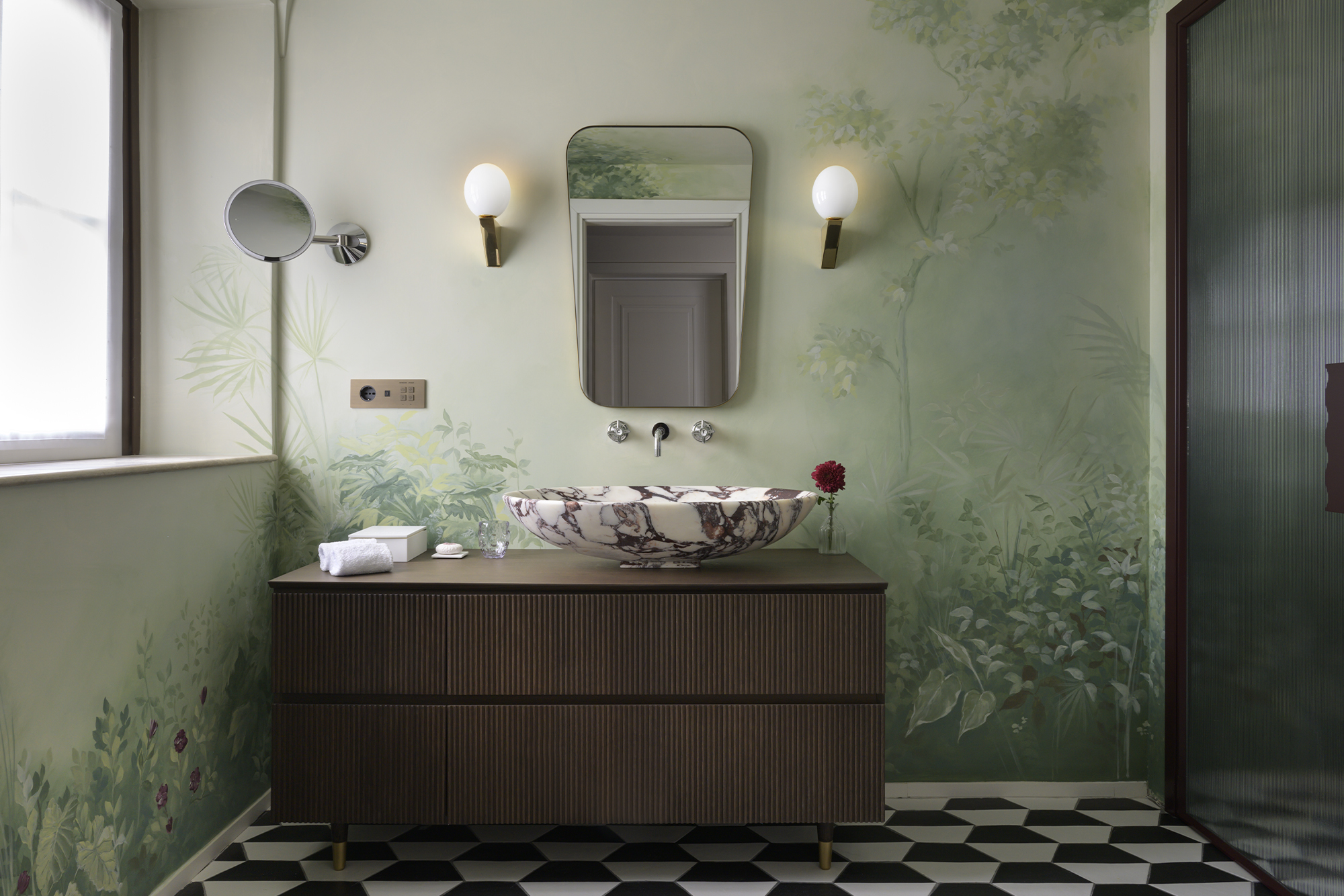 green bathroom with white checkered floor and wood-coloured vanity