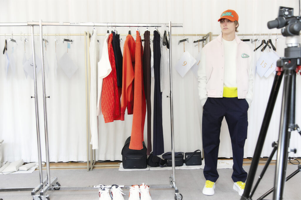 Spring Dior and KAWS Capsule, model shows white jacket behind the scenes