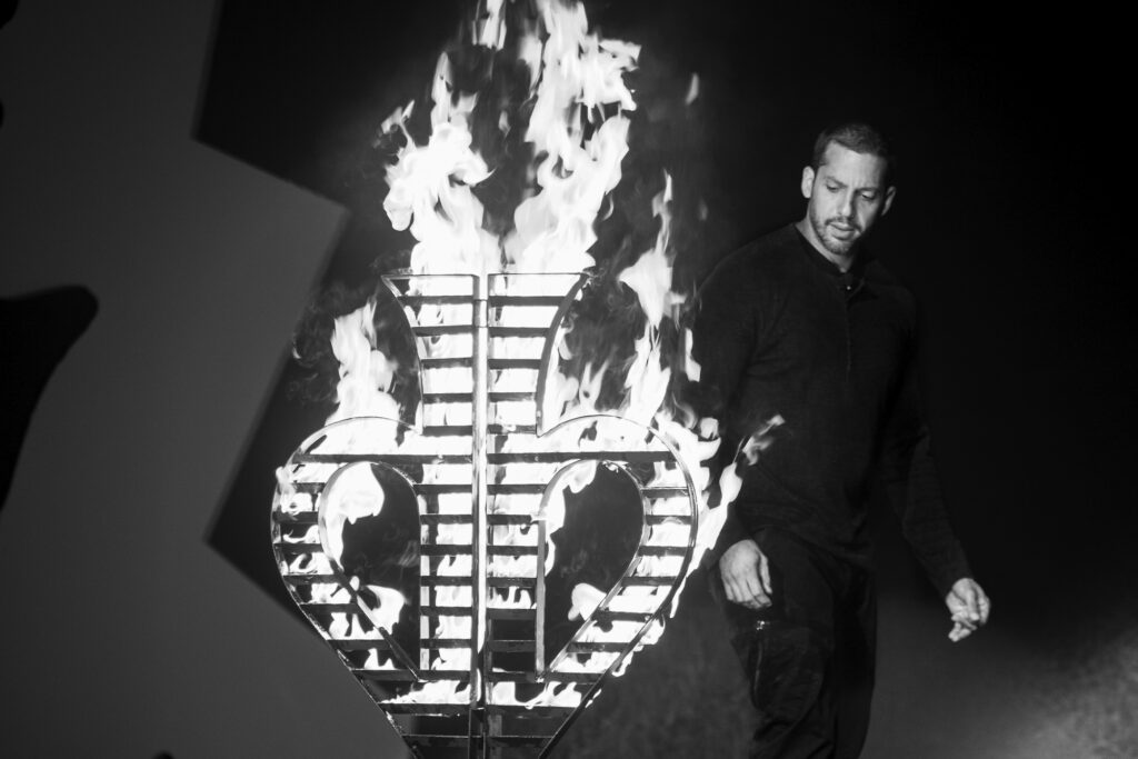 David Blaine black and white portrait next to flame