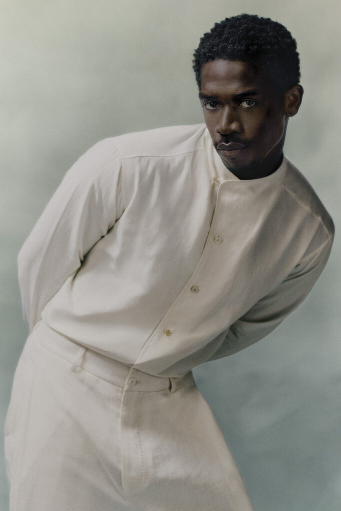 Damson Idris WEARS LORO PIANA IN FRONT OF SKY BLUE BACKGROUND