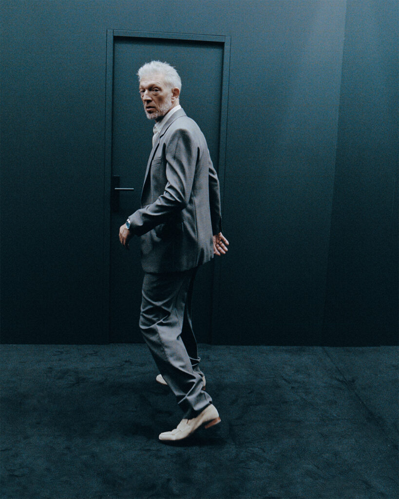 SUIT BY SAINT LAURENT BY ANTHONY VACCARELLO SHIRT BY LORO PIANA SHOES BY CHURCH’S NECKLACE BY BVLGARI WATCH BY AUDEMARS PIGUET 5-2025 Vincent Cassel