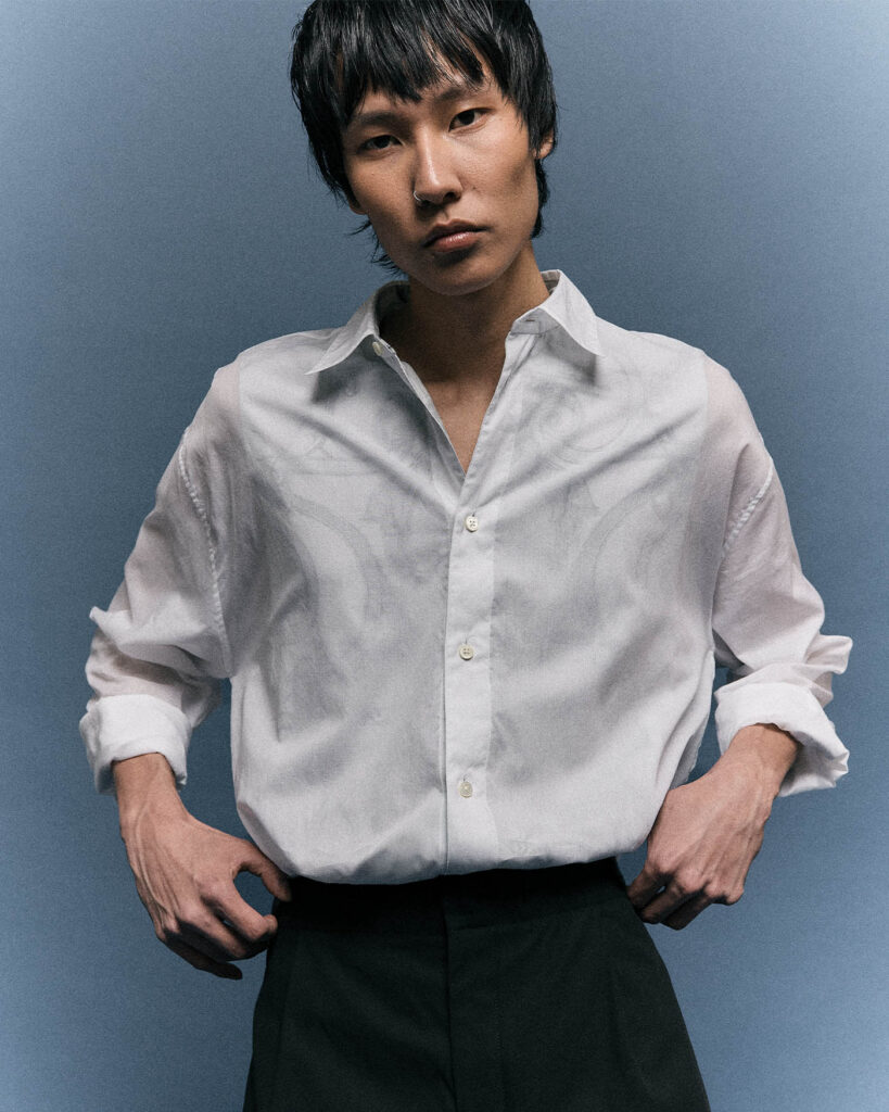 model wears white chemise and black trousers