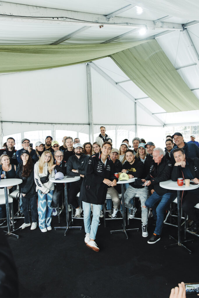 Formula One team poses in a tent