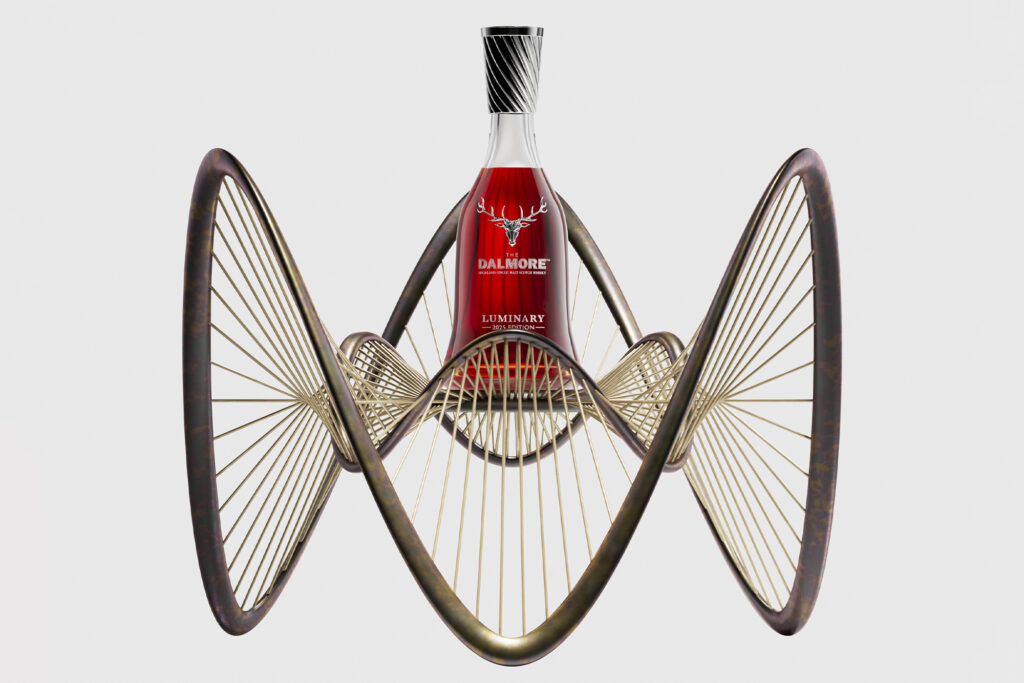 Architect Ben Dobbin designs The Dalmore Luminary No. 3 — 2025 Edition. Photo shows bottle of whiskey with curved wheel design
