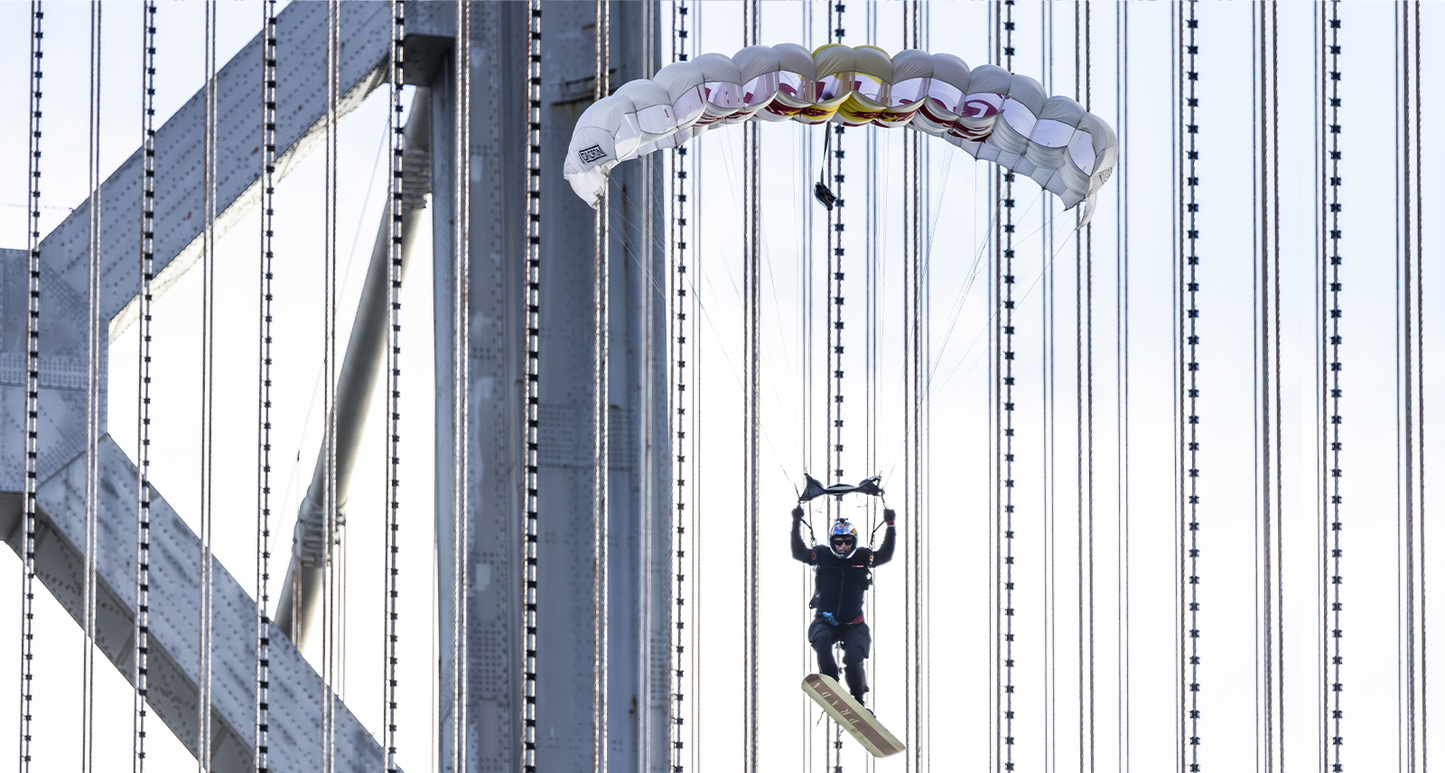Athlete Sean MacCormac Skysurfs for Prada Linea Rossa and Red Bull over San Francisco Bridge