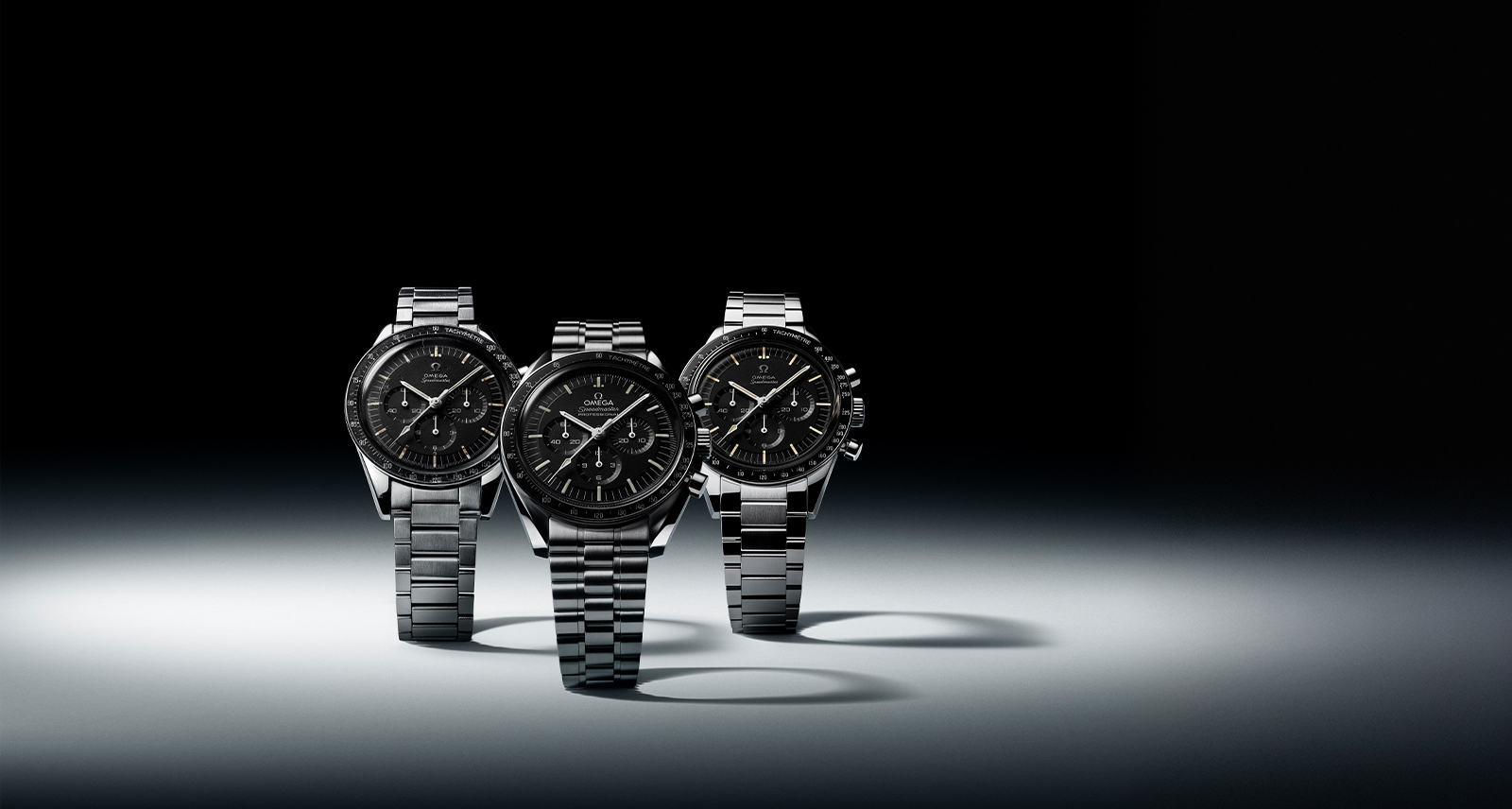 3 OMEGA Speedmaster men's watches against a black background