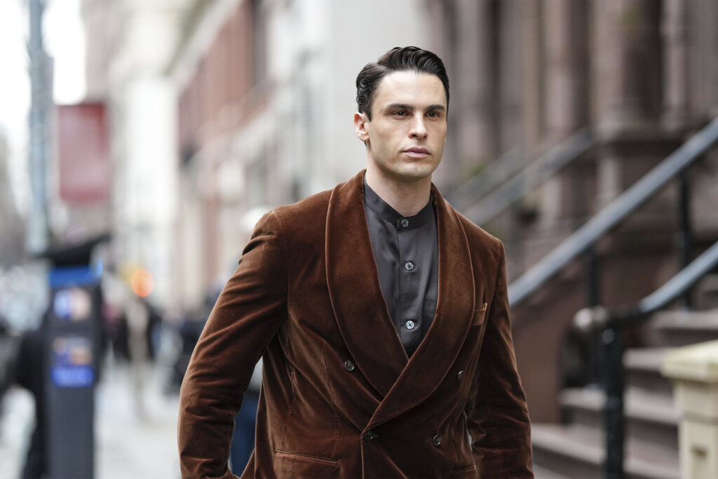 Baptiste Giabiconi wears a brown double breasted velvet blazer jacket , a gray shirt, outside Todd Snyder, during New York Fashion Week, on February 06, 2025 in New York City. (Photo by Edward Berthelot/Getty Images)