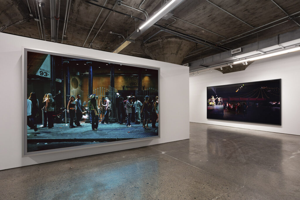 Jeff Wall, In front of a nightclub, 2006. Transparency in light box. Collection of the Museum of Contemporary Art Chicago, gift of Katherine S. Schamberg by exchange, 2006.30.a–c, Band & crowd, 2011. Lightjet Print. Jeff Wall Photographs 1984–2023, installation view, MOCA Toronto, 2025. Photo: LF Documentation. © Jeff Wall.