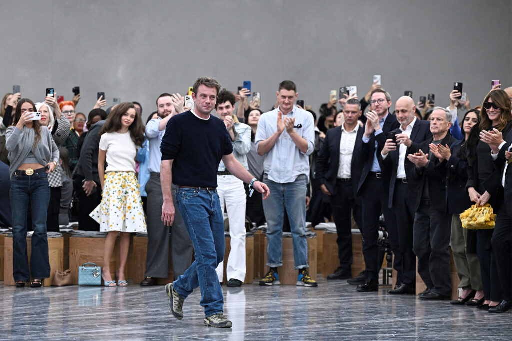 Jonathan Anderson, creative director of Loewe and designer of Dior’s Spring/Summer 2026 collection, takes a bow after blending office and off-duty codes on the Paris runway. (photo: Julien de Rosa, Getty Images)