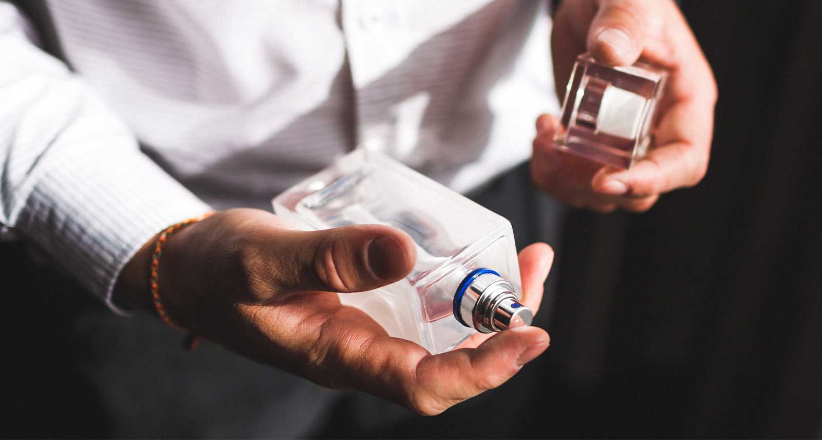 Scent Layering for Men photo shows man holding a bottle of cologne