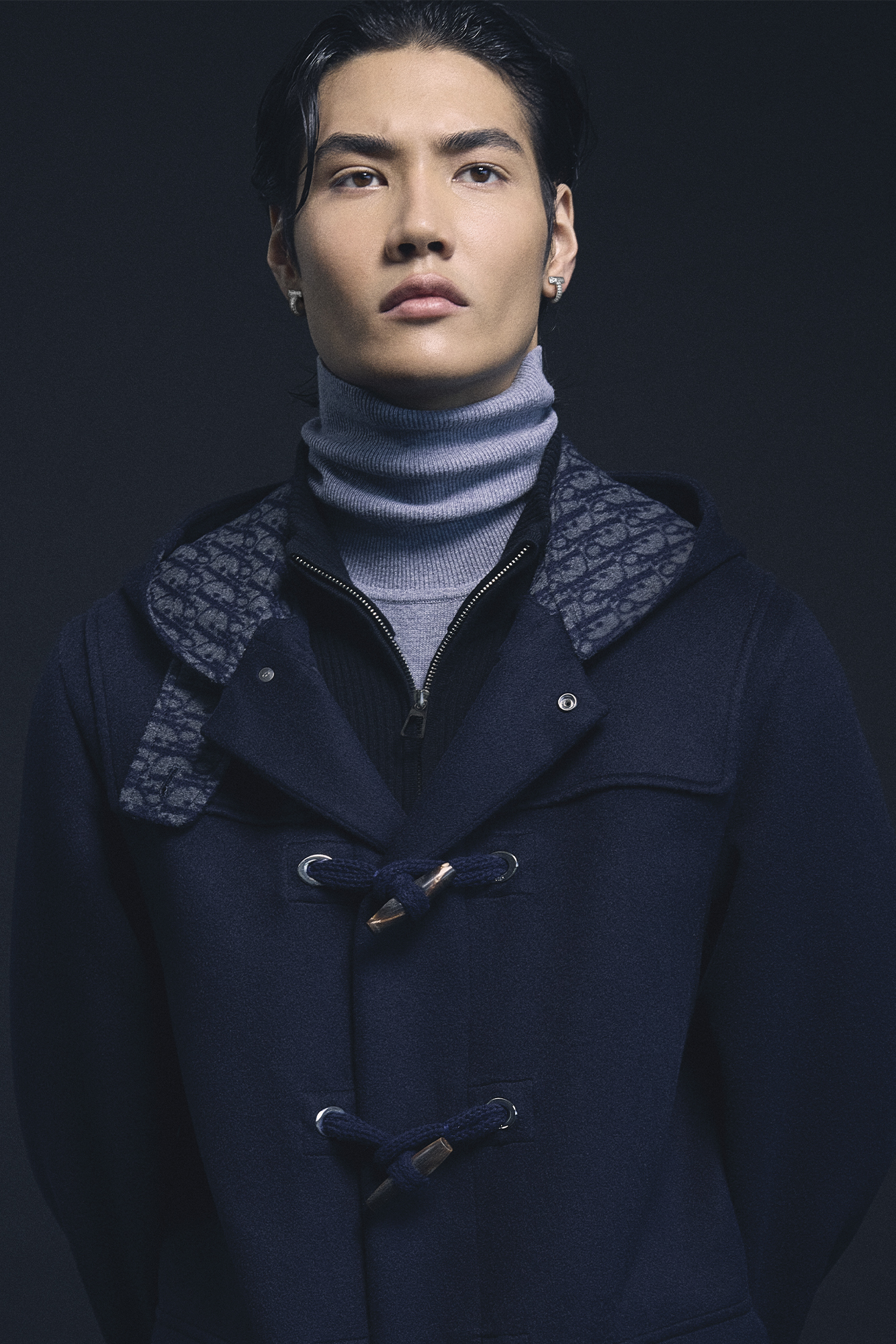 COAT ($11,000) BY DIOR MEN; TURTLENECK ($320) AND CARDIGAN ($445) BY ÇA VA DE SOI; EARRINGS ($10,600) BY TIFFANY & CO.