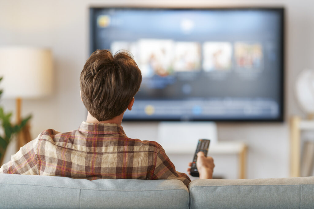 man watching television at home