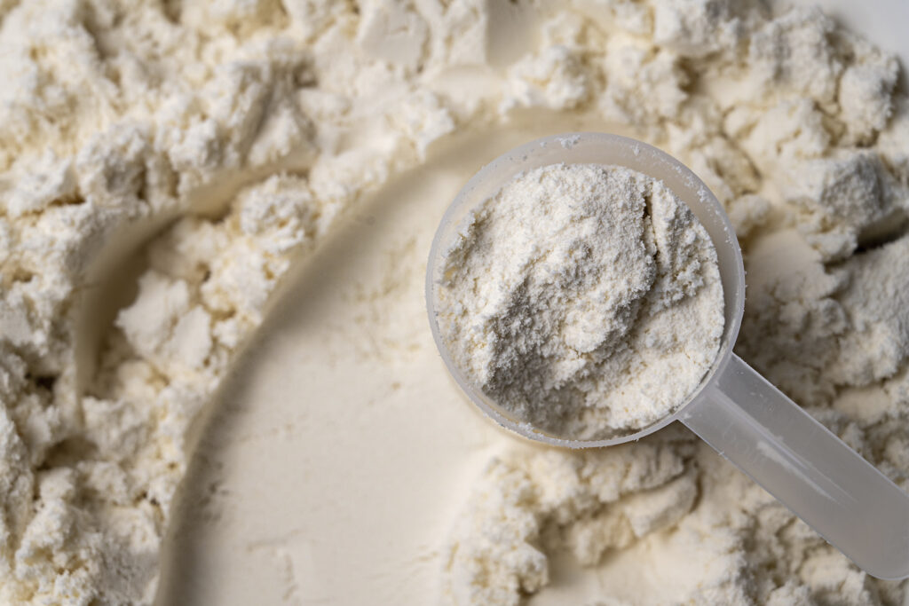 close up of a scoop of vanilla whey protein.