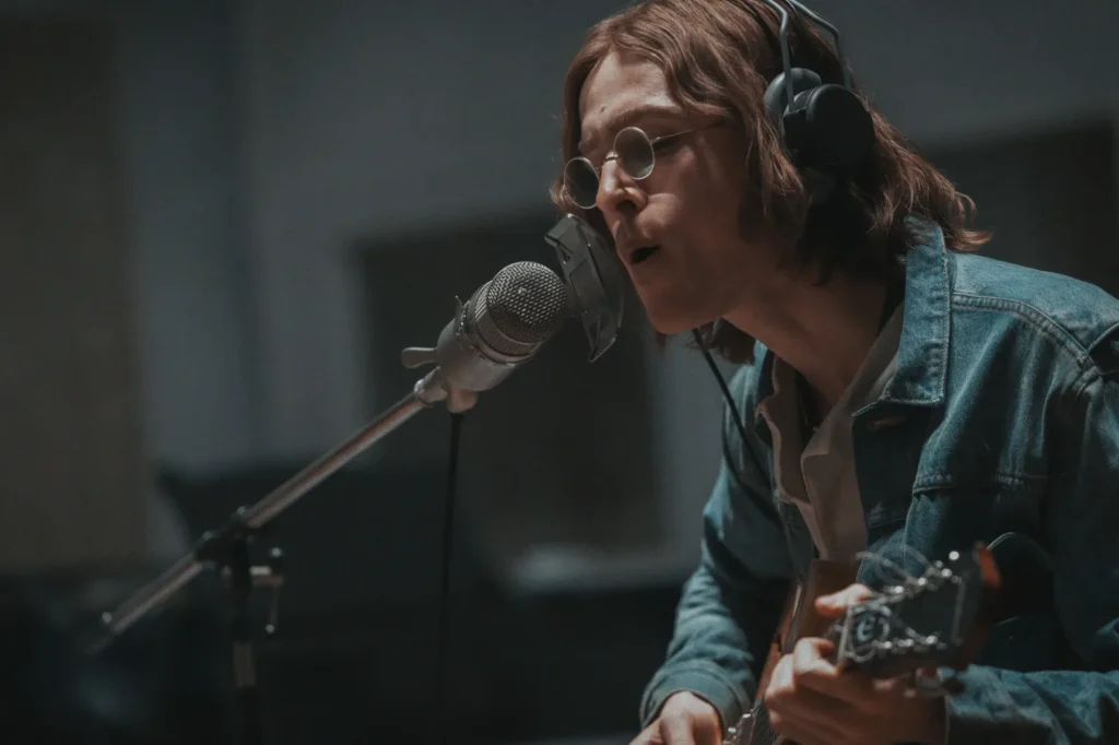 Harris Dickinson as John Lennon in The Beatles – A Four-Film Cinematic Event (Courtesy of Sony Pictures)