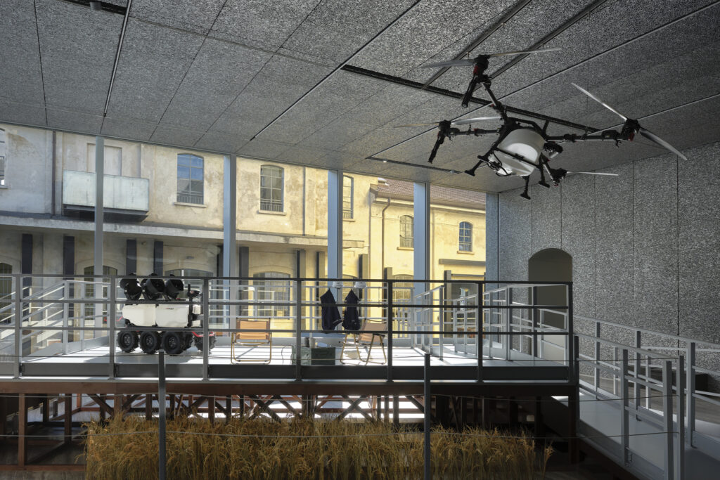 Exhibition view of “Dash” by Cao Fei Photo: Marta Marinotti and Federico Floriani Courtesy Fondazione Prada Cao Fei Dash, 2026 Multimedia installation, variable dimensions A 47’05” double-screen video, 9 surrounding photography installations, paddy field structures, weather stations, XAG agricultural drones, unmanned vehicles and promotional clips, furniture Structure of the installation developed by Small Production Courtesy of the Artis, Vitamin Creative Space and Sprüth Magers Work produced by Fondazione Prada on the occasion of the exhibition “Dash”
