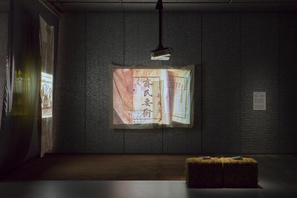 Exhibition view of “Dash” by Cao Fei Photo: Marta Marinotti and Federico Floriani Courtesy Fondazione Prada Cao Fei Land of Plenty, 2026 Slide installation, variable dimensions Two slide projectors, a set of slides, two projection screens assembled from grain and cotton sacks Slides from China Agriculture Series: Color Educational Slide Films, edited by Publicity Office of the Ministry of Agriculture, Animal Husbandry and Fisheries, China Agricultural Association, China Audio-Visual Research Center, 1984, Private Collection Courtesy of the Artist Work produced by Fondazione Prada on the occasion of the exhibition “Dash”