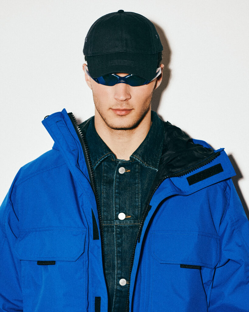 JACKET ($795) BY CANADA GOOSE; SHIRT ($169) AND HAT ($69) BY COS; SUNGLASSES ($430) BY GENTLE MONSTER 