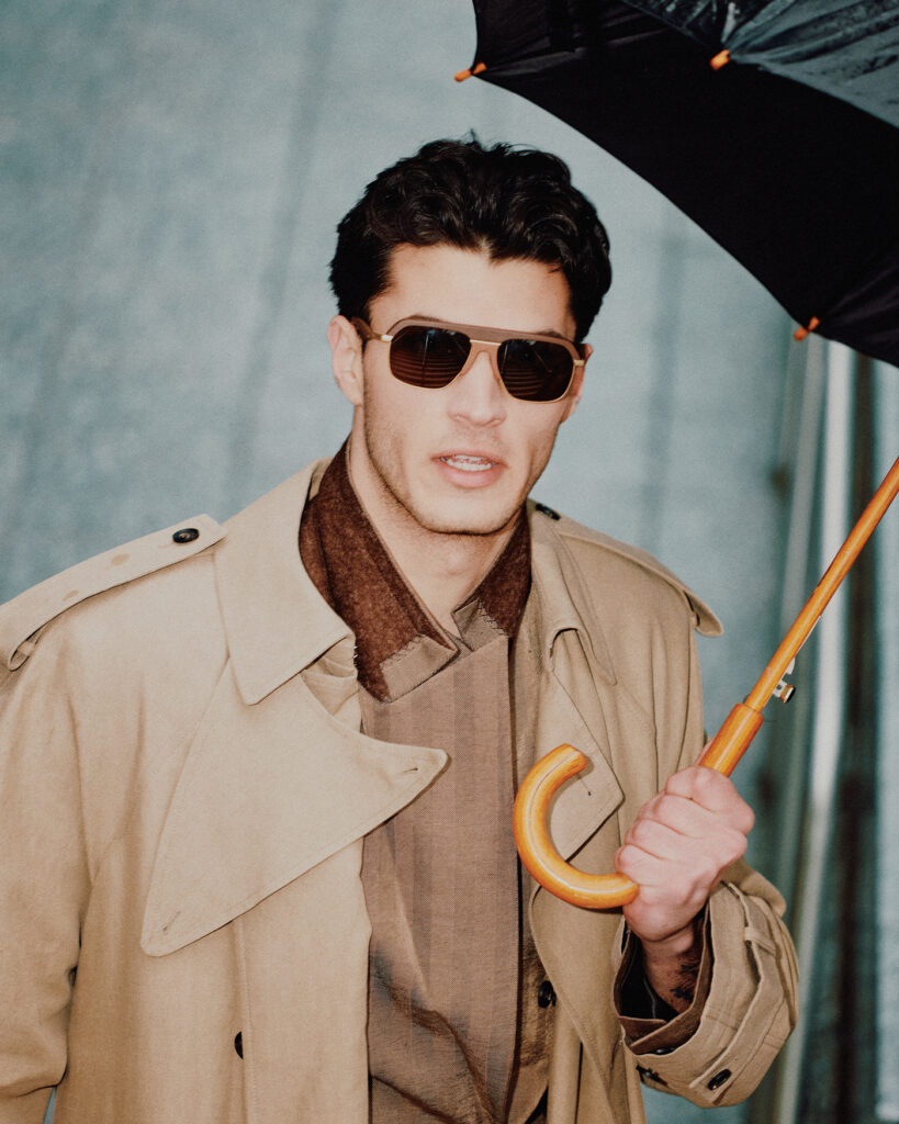 COAT (PRICE UPON REQUEST) AND BLAZER (,800) BY FERRAGAMO; SUNGLASSES (5) BY FERRARI, AT SUNGLASS HUT®; UMBRELLA, STYLIST’S OWN. 
