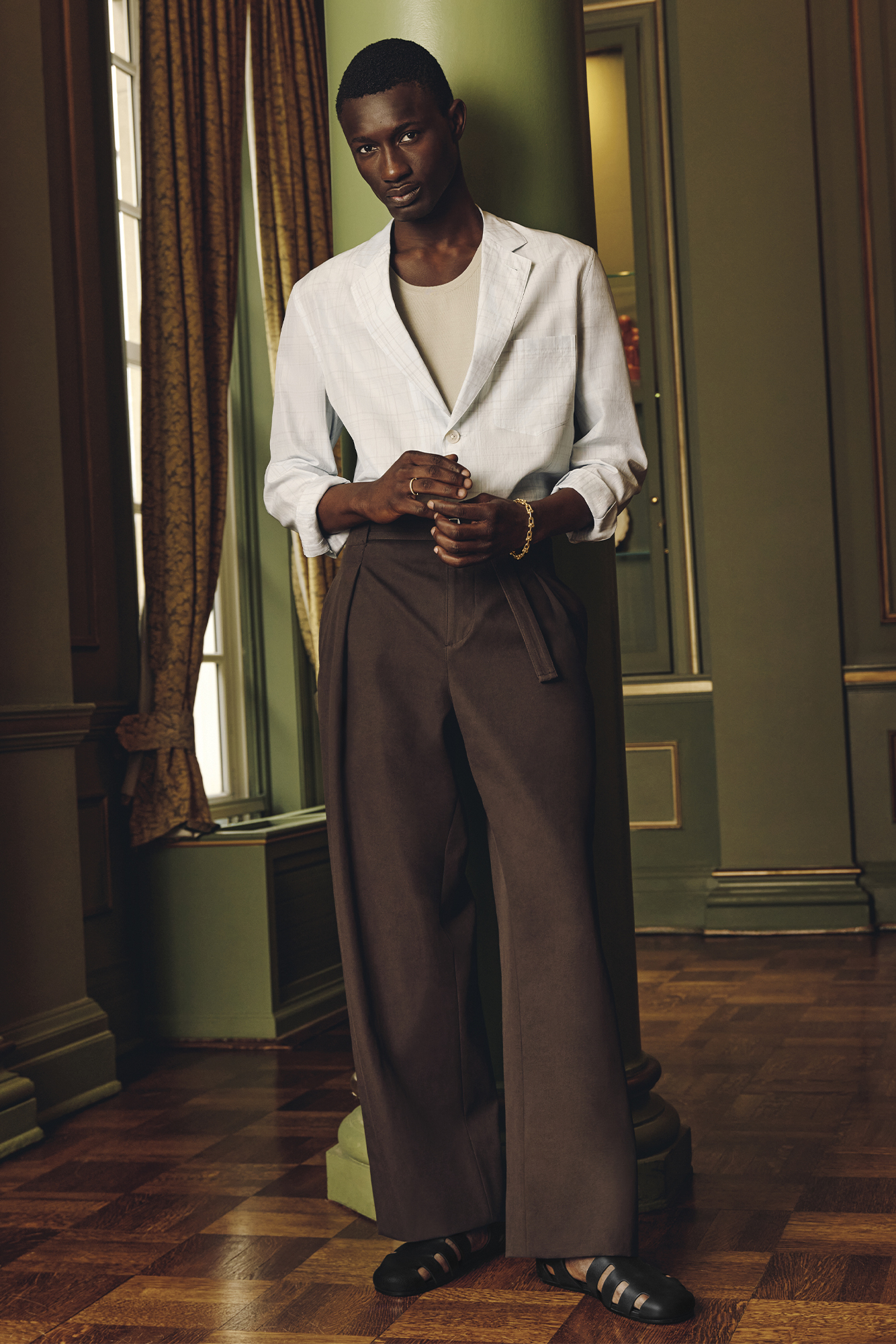 JACKET ($4,875), TANK TOP ($1,875), PANTS ($2,050), AND SHOES ($1,650) BY HERMÈS; RING ($5,750) AND BRACELET ($12,000) BY TIFFANY & CO.
